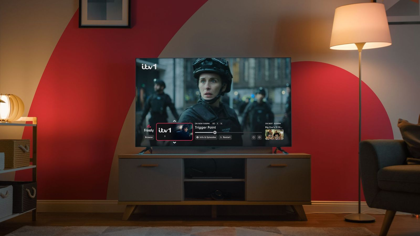 Freely TV in a red living room, Trigger Point is playing on the screen