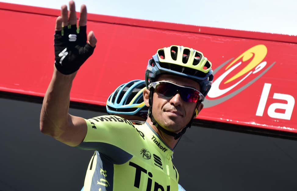 Alberto Contador waves to the crowd at the start of stage 13