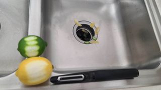 A garbage disposal unit with citrus peels down it