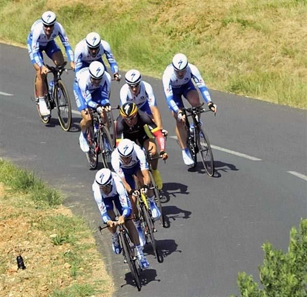 The Quick Step team races around a bend.