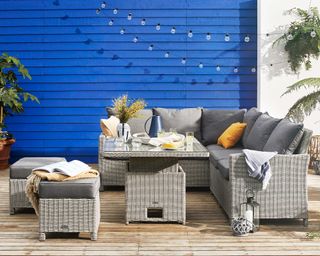 decking with blue fence and Dorset Compact Corner Lounge Set with Rising Table from Furniture Village