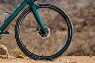 A turquoise fork and black wheel in a desert