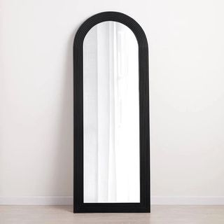 Black Carved Wood Arch Mirror standing in room