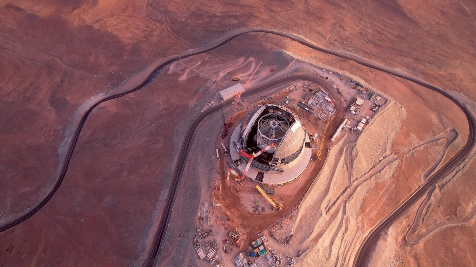 a domed metal building in the desert