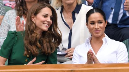 Kate Middleton and Meghan Markle in the Royal Box on Centre Court during day twelve of the Wimbledon Tennis Championships at All England Lawn Tennis and Croquet Club on July 13, 2019