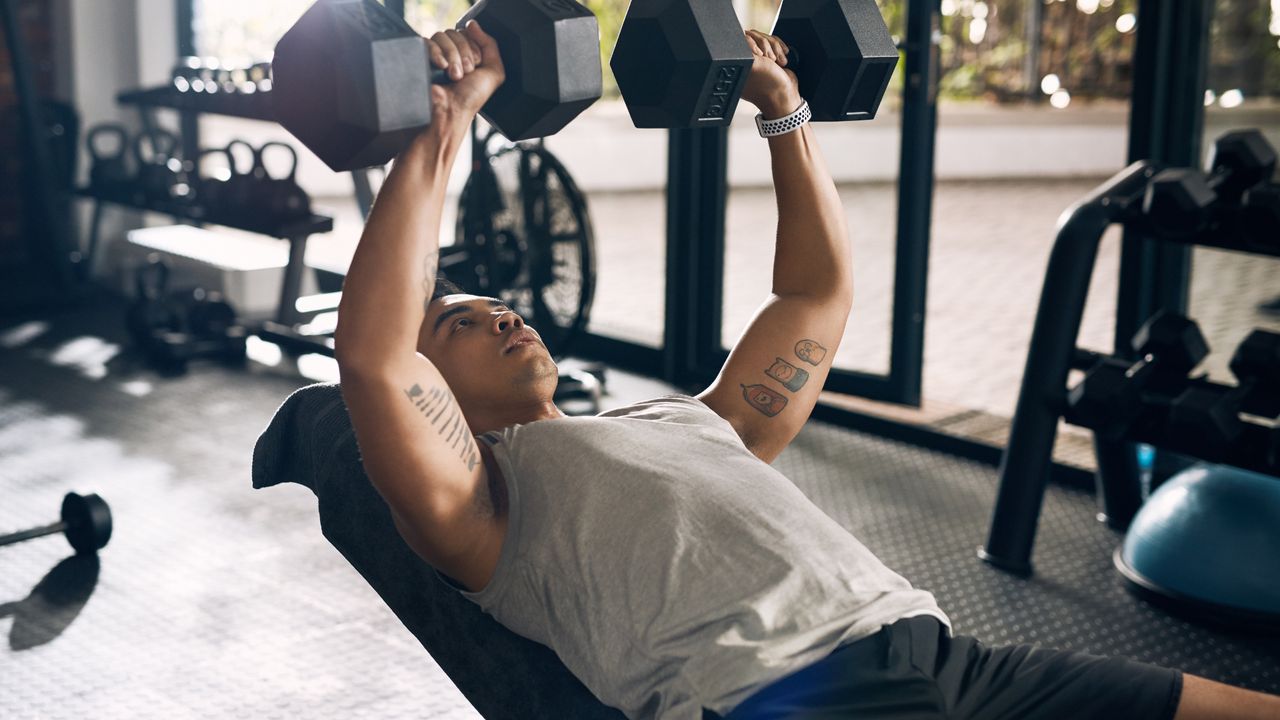 Man performing dumbbell bench presses