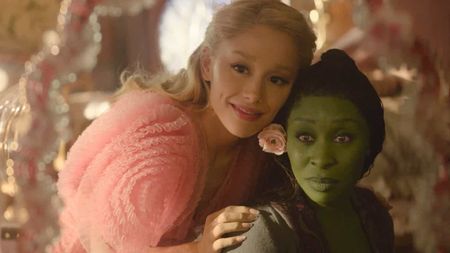 Ariana Grande and Cynthia Erivo looking into a mirror in Wicked