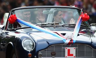 Prince William driving vintage Aston Martin with wife Kate Middleton on their wedding day