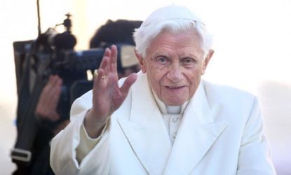 Pope Benedict XVI waves to the faithful as he arrives in St Peter's Square for his final general audience on Feb. 27, one day before he resigns.