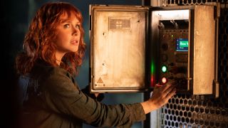 Bryce Dallas Howard looks up in fear as she activates a switch in Jurassic World Dominion.