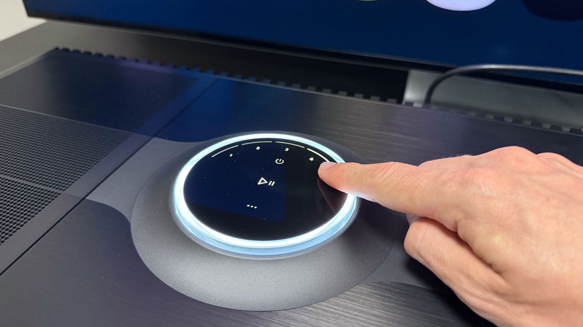 Focal Mu-so Hekla review: a potent, super-immersive wireless speaker in a sleek soundbar's clothing 6 A man's hand operating the Focal Mu-so Hekla's dial.