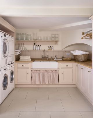 Martin Moore pink laundry room with double appliances
