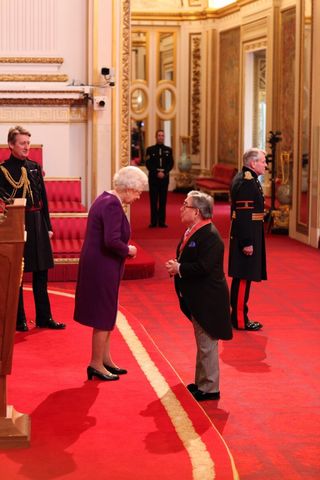 Mr. Ronald Corbett from Croydon is made a CBE by Queen Elizabeth II at Buckingham Palace. (Jonathan Brady/PA)