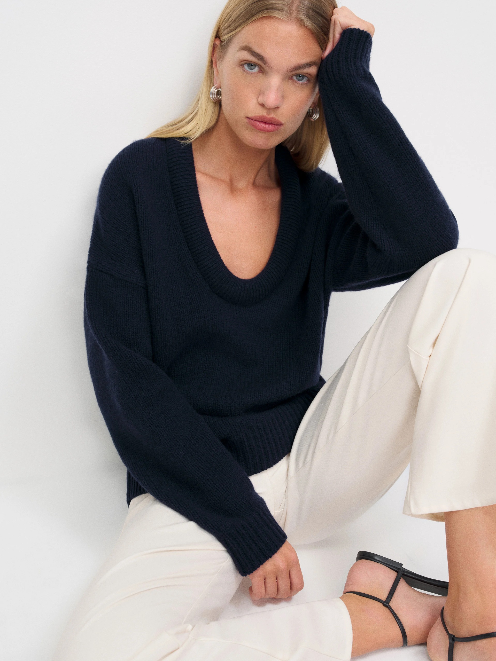 A model wearing the Reformation Jonie sweater