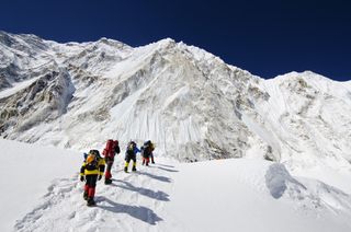 Climbers walk below Nuptse as they make their way to camp 2 on Mount Everest in this undated photo.
