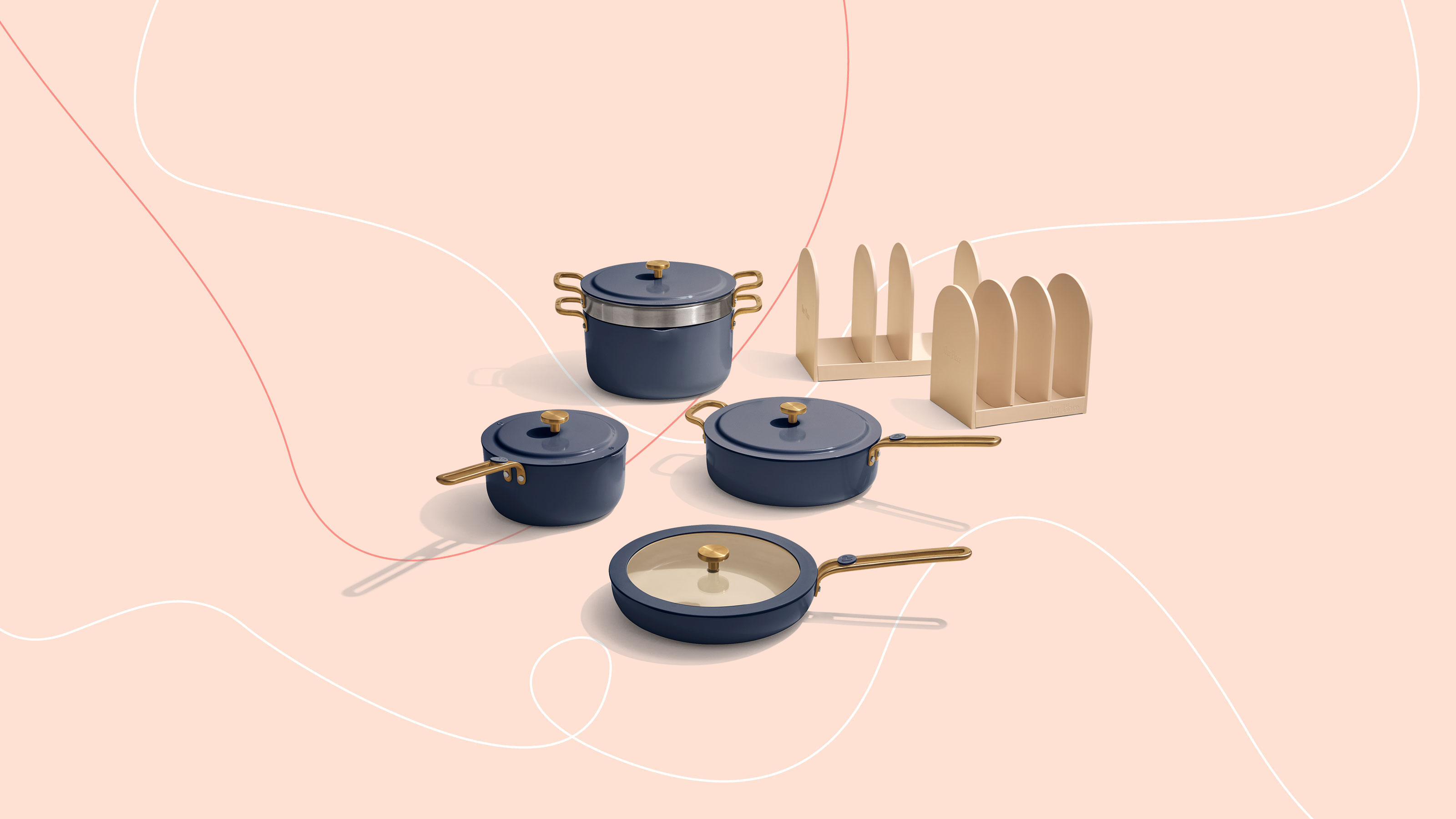 Our Place Essentials pan set on graphic, pink background