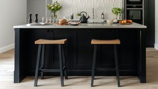 black painted kitchen with wood top bar stools