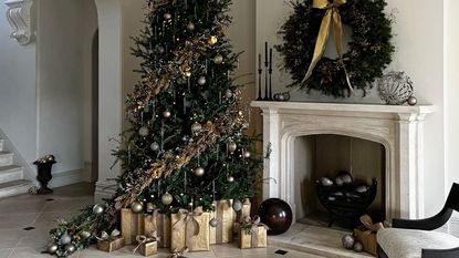 a christmas tree with gold decorations and a wreath over a fireplace