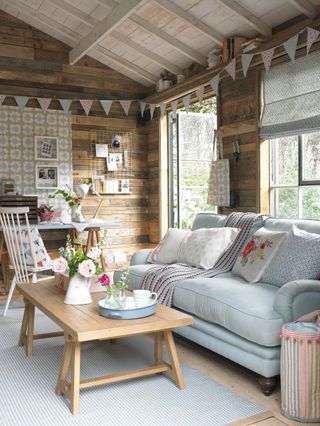 she shed interior with bunting and sofa