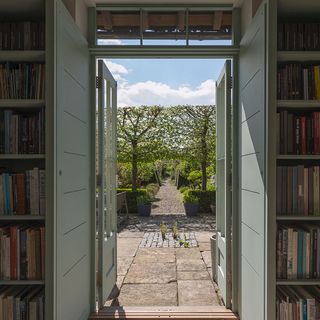 room with book shelve and trees