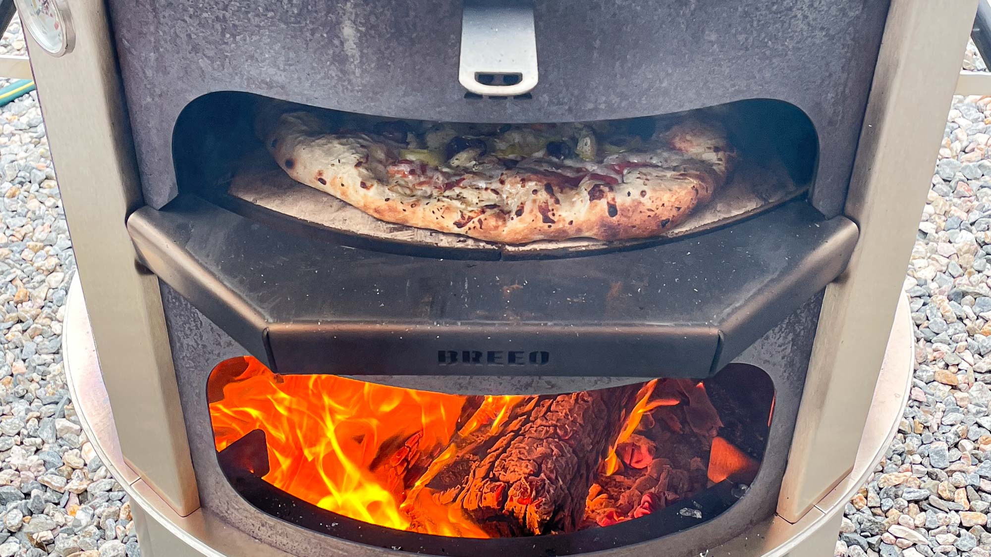 Breeo Live-fire pizza oven bundle in back yard