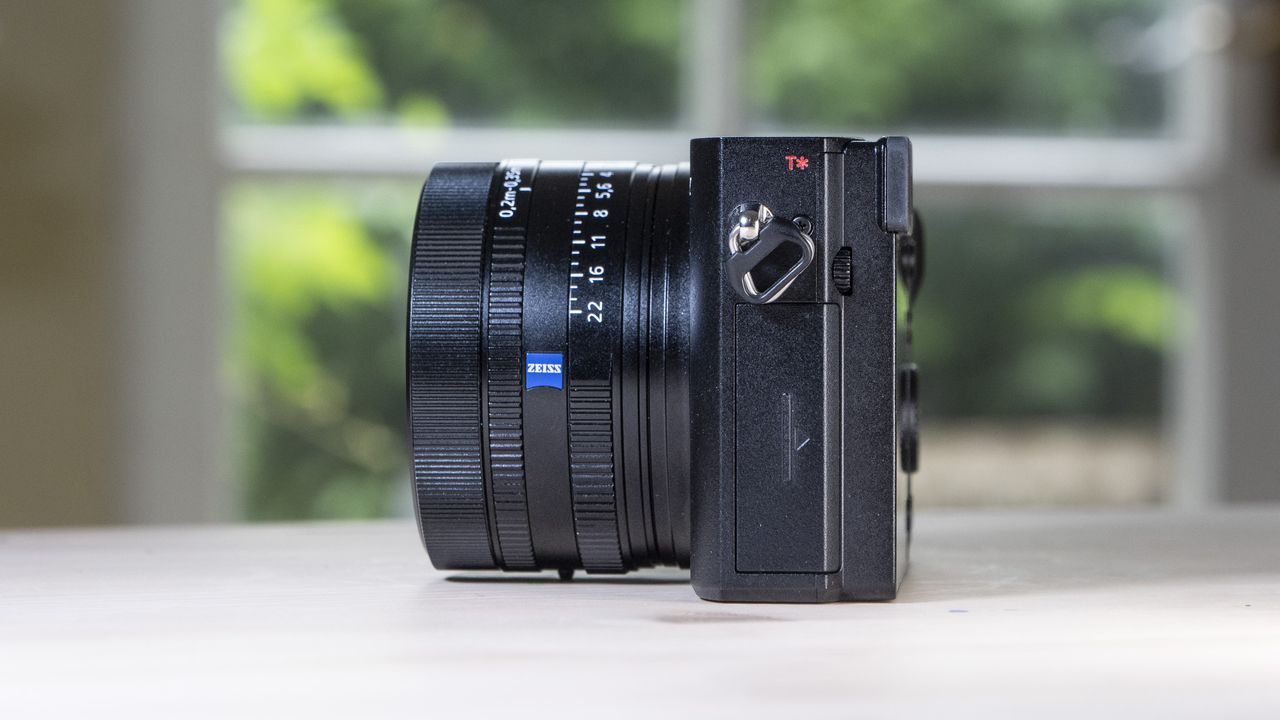 Side profile of the Sony RX1R III compact camera, on a wooden table