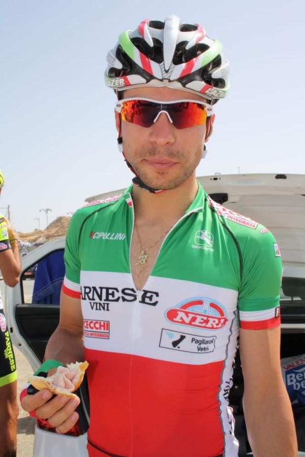 Italian national champion Giovanni Visconti enjoys a snack before the start