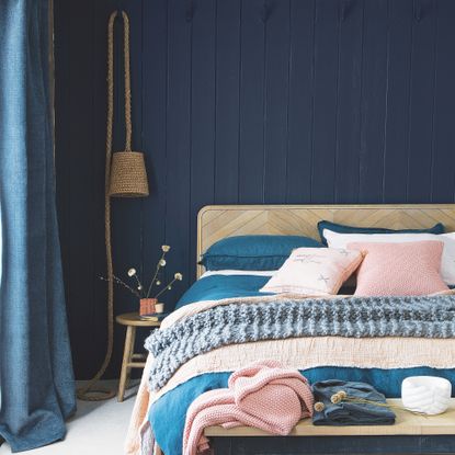 dark blue bedroom with wall lighting