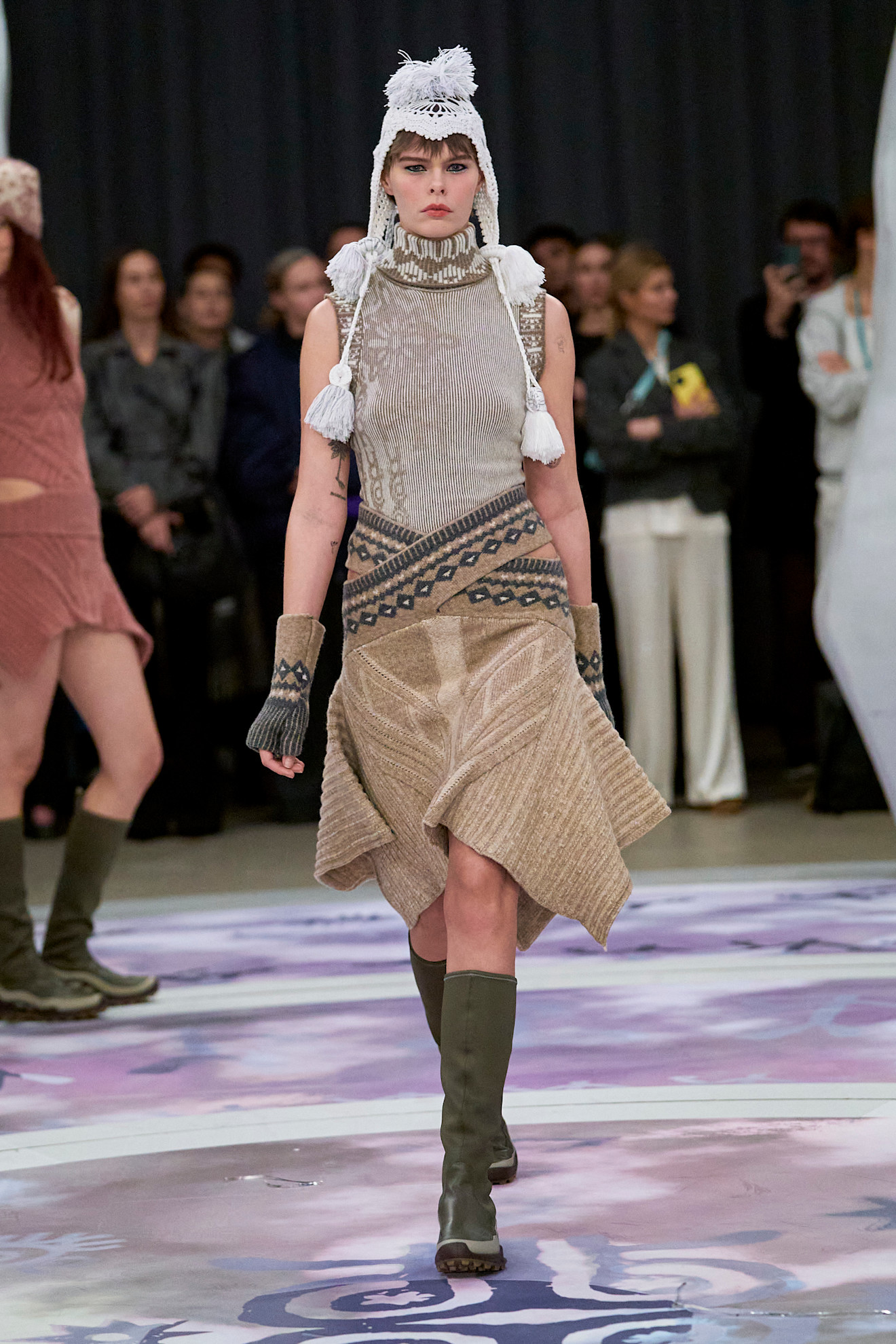 Runway model wearing a knit skirt.