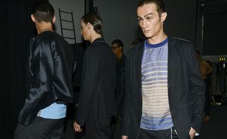 Model wearing a blue striped t shirt and blazer
