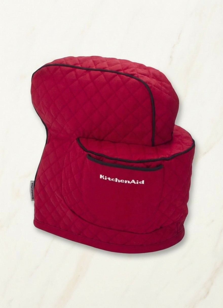 Red KitchenAid accessory on cream marble background