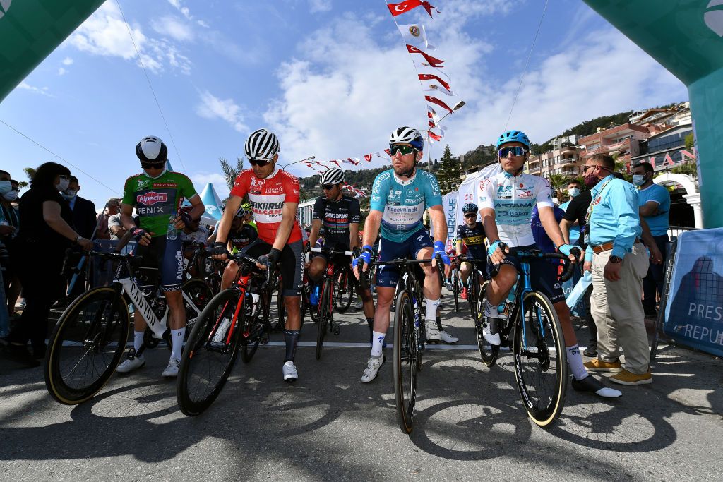KEMER TURKEY APRIL 14 Start Jasper Philipsen of Belgium and Team AlpecinFenix Green Points Jersey Vitaliy Buts of Ukraine and Salcano Sakarya BB Cycling Team Red Mountain Jersey Mark Cavendish of United Kingdom and Team Deceuninck QuickStep Turquoise Leader Jersey Artyom Zakharov of Kazahkstan and Team Astana Premier Tech White Beauties of Turkey Jersey during the 56th Presidential Cycling Tour Of Turkey 2021 Stage 4 a 1844km stage from Alanya to Kemer Oakley Sunglasses TUR2021 tourofturkeyTUR on April 14 2021 in Kemer Turkey Photo by Stuart FranklinGetty Images