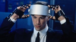 Keanu Reeves about to pull down a VR headset