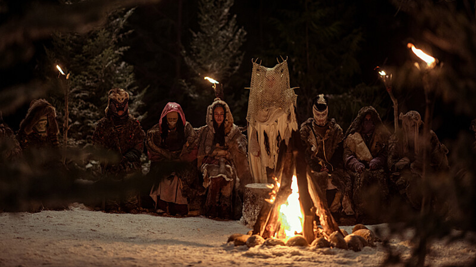 The girls gather around the fire in Yellowjackets season 3