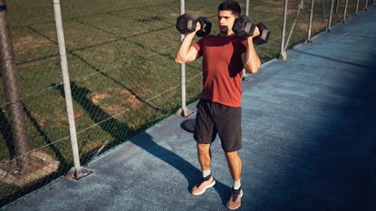A man exercising with dumbbells