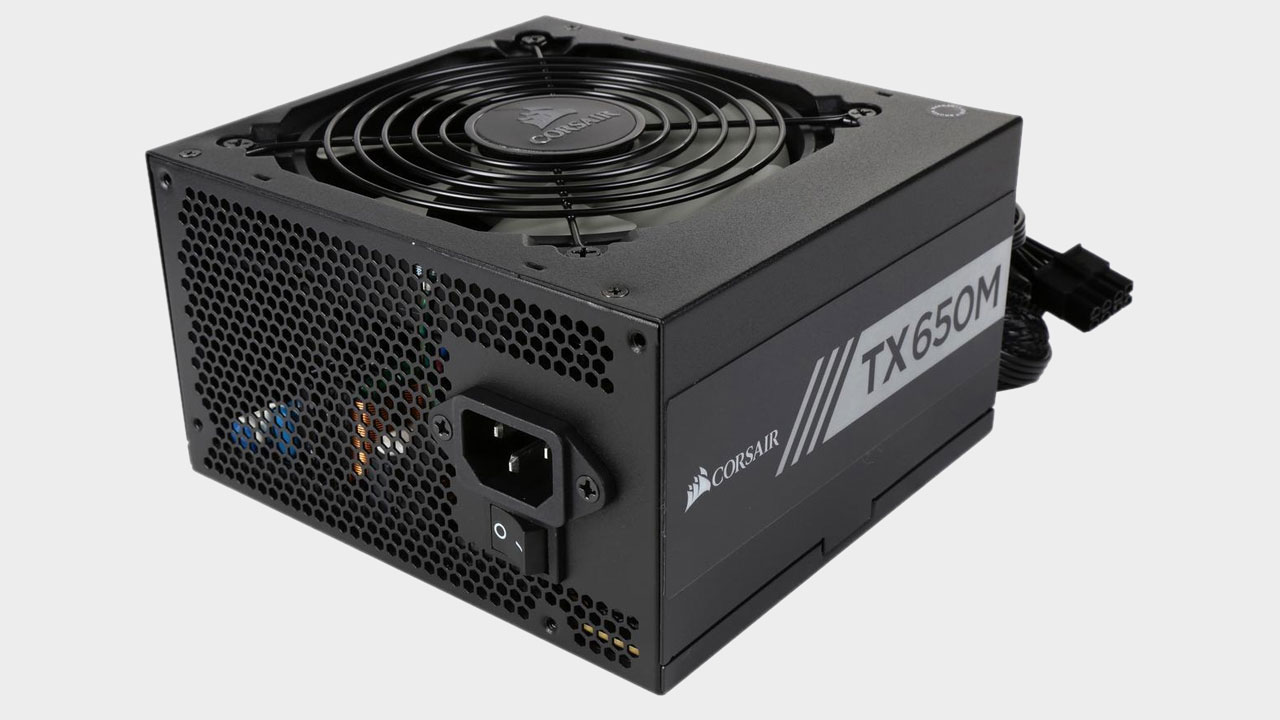 Corsair TX650M 650W power supply shot at an angle on a blank background