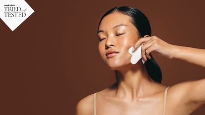 Lymphatic drainage: A woman using a gua sha on her face