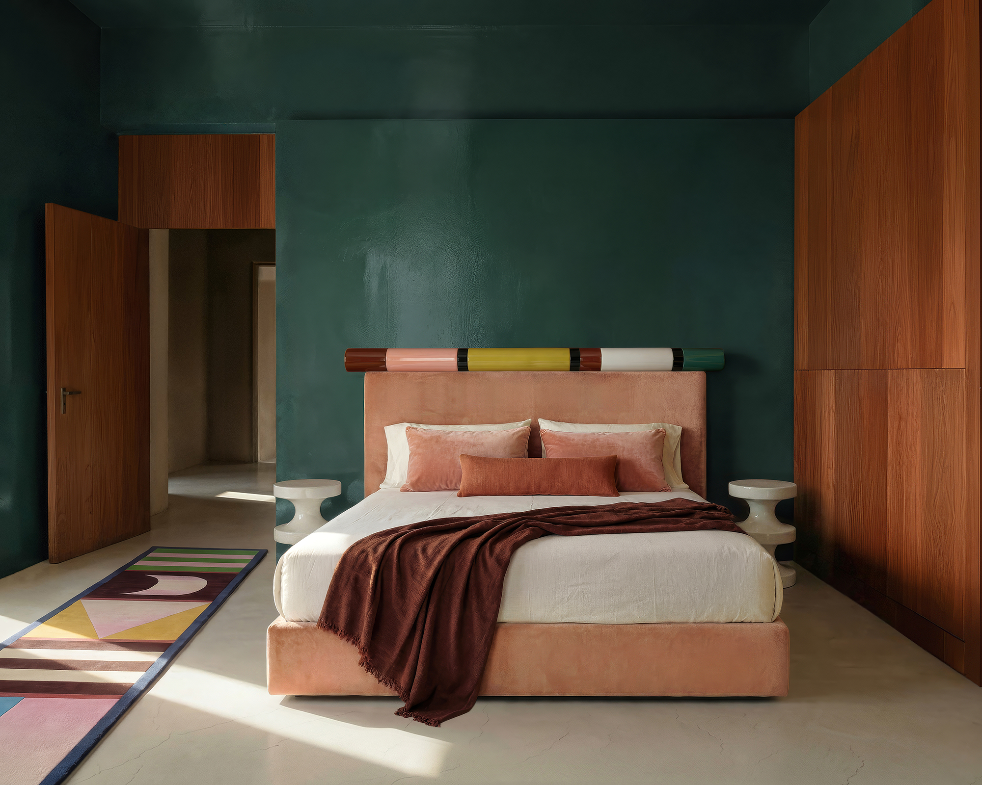 colorful bed against a deep blue wall