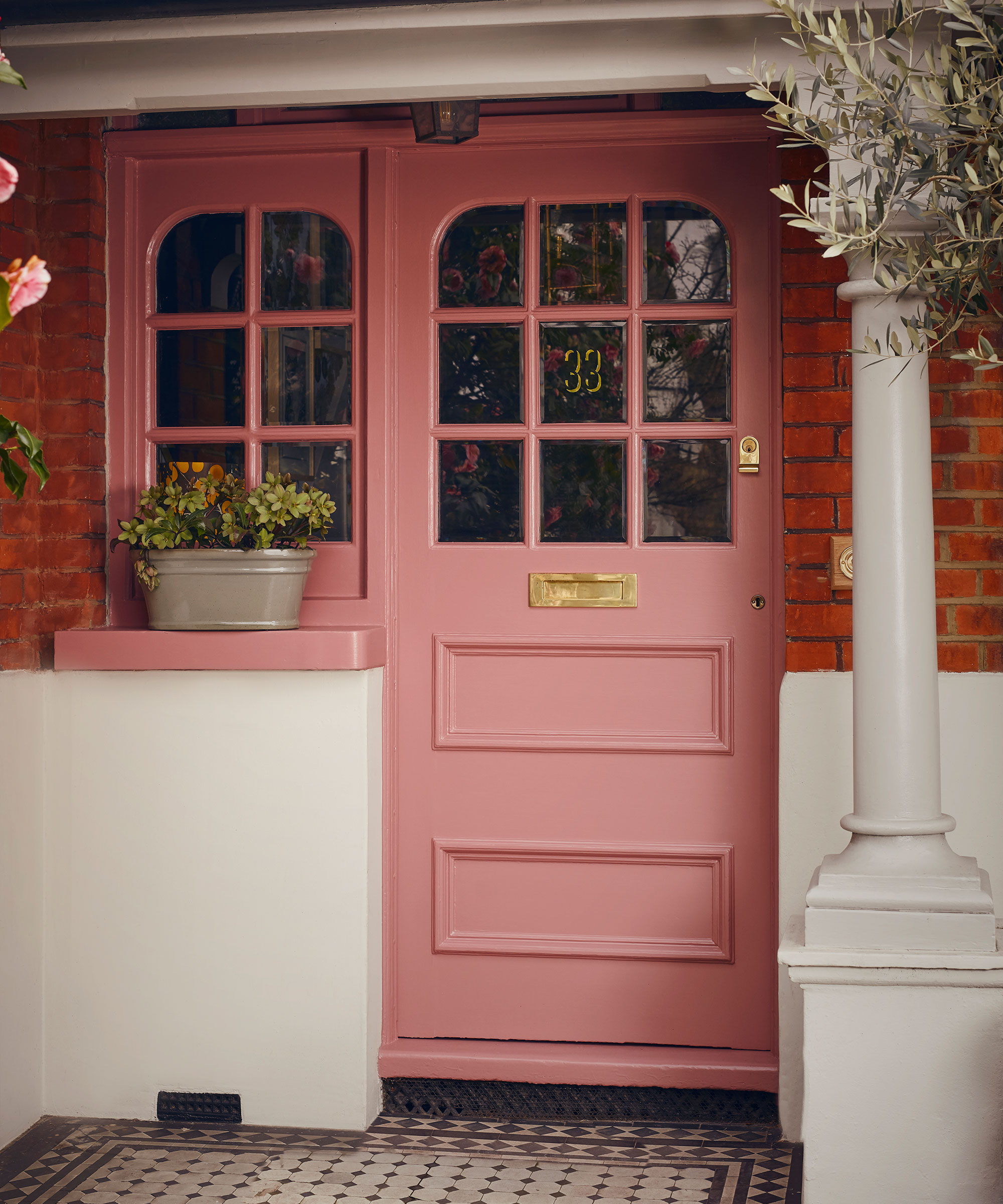 pink front door with glazed top and sidelights