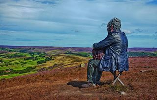 Seated figure on the North York Moors by Simon Penson