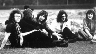 1969: (L-R) Guitarist Robert Fripp, drummer Michael Giles, singer and guitarist Greg Lake, multi-instrumental Ian McDonald and lyricist Peter Sinfield which consisted of the first lineup of the English rock band "King Crimson" pose for a portrait sitting in a field in 1969.
