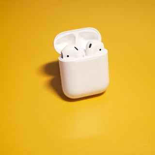 airpods against a yellow background