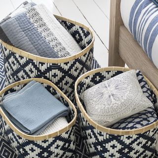 bedroom with wooden flooring and basket with cloths