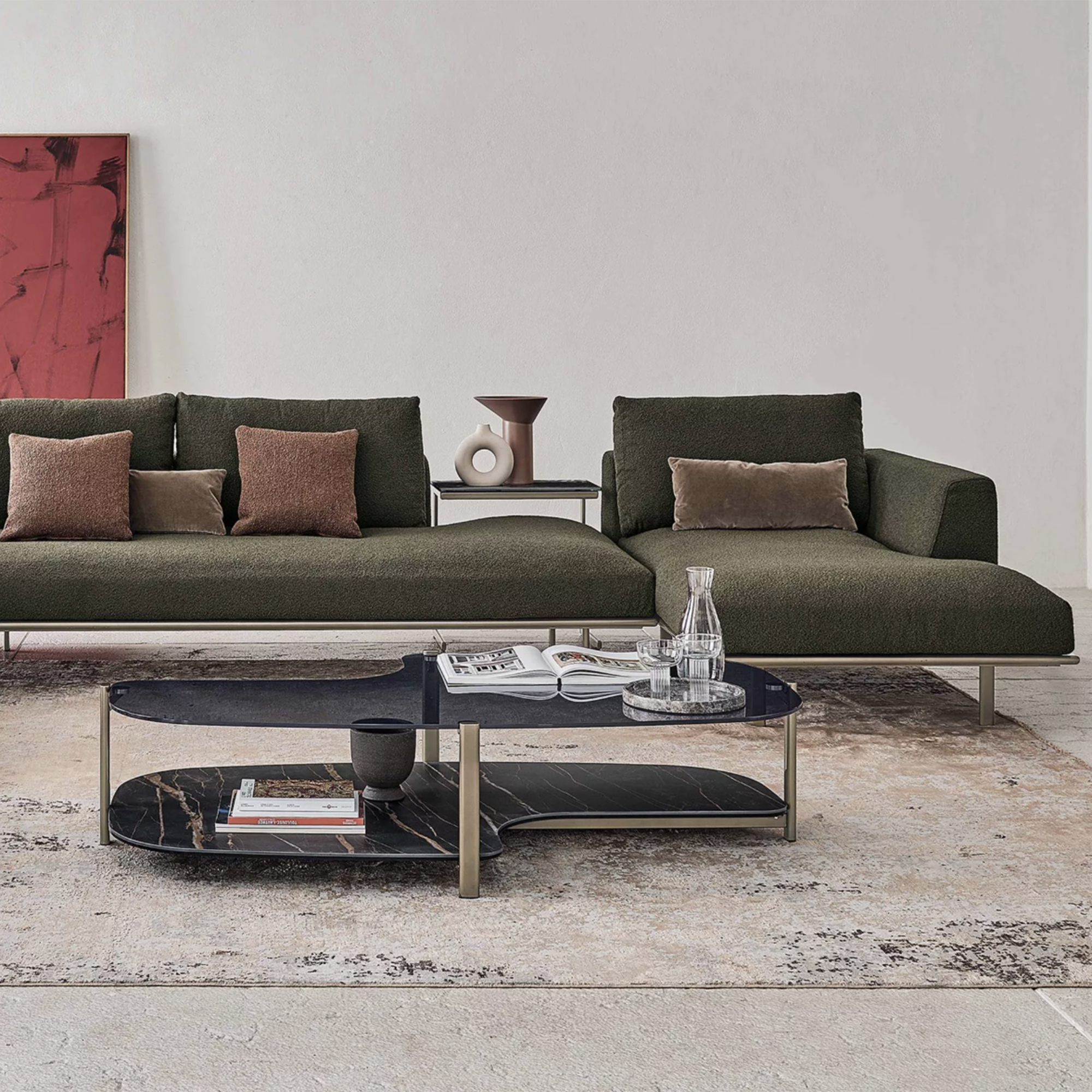 low and modern green sofa in a grey living room