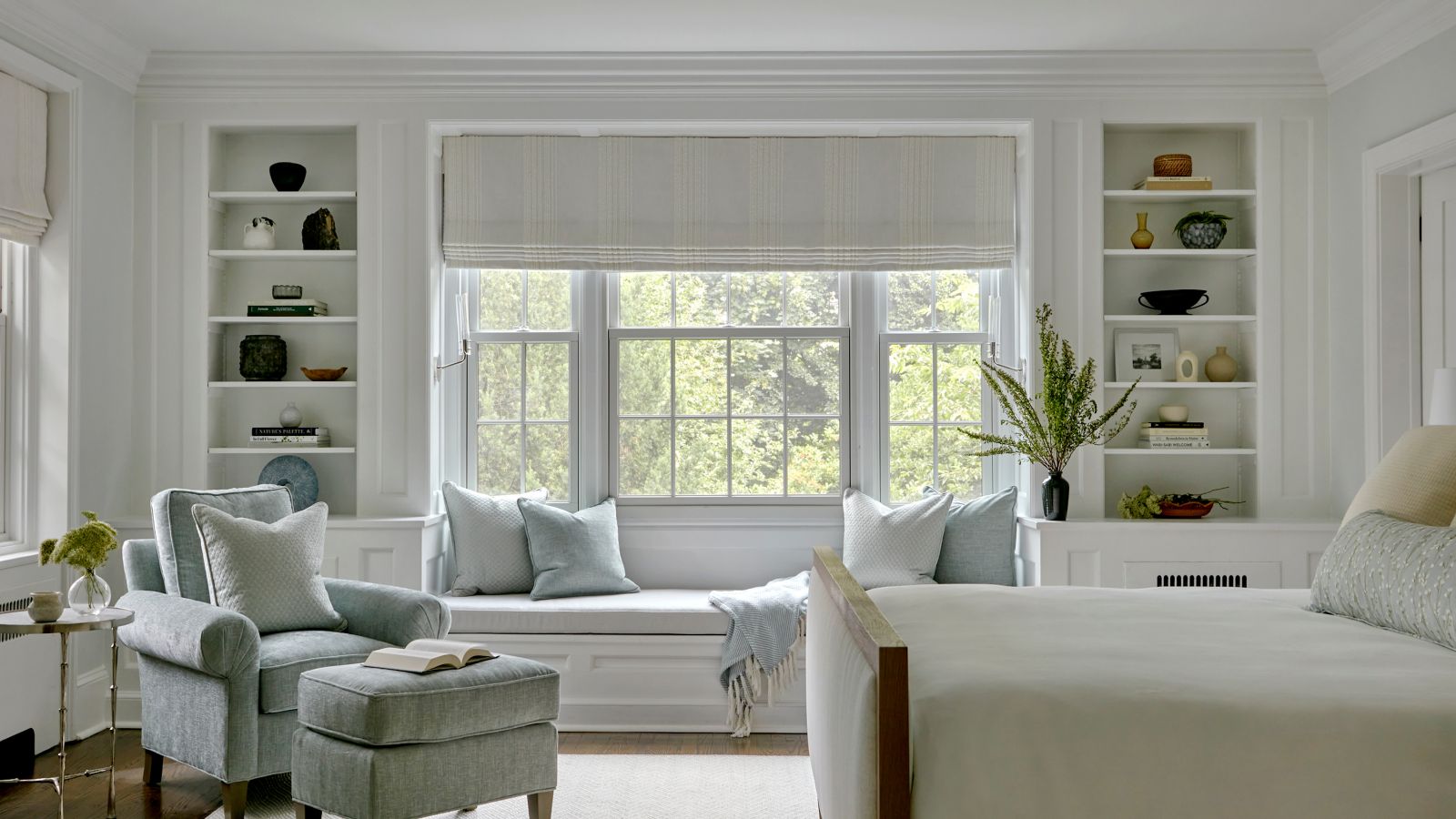 neutral bedroom with large window and window seat