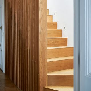 Hallway with wooden stairs and modern wooden panelling