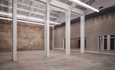 Large space with exposed brickwork and white girders
