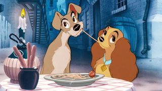 Cartoons of the 1950s - best animated movies of the 50s; A heartwarming animated scene depicts two canine characters sharing a meal of spaghetti and meatballs at a table outdoors.