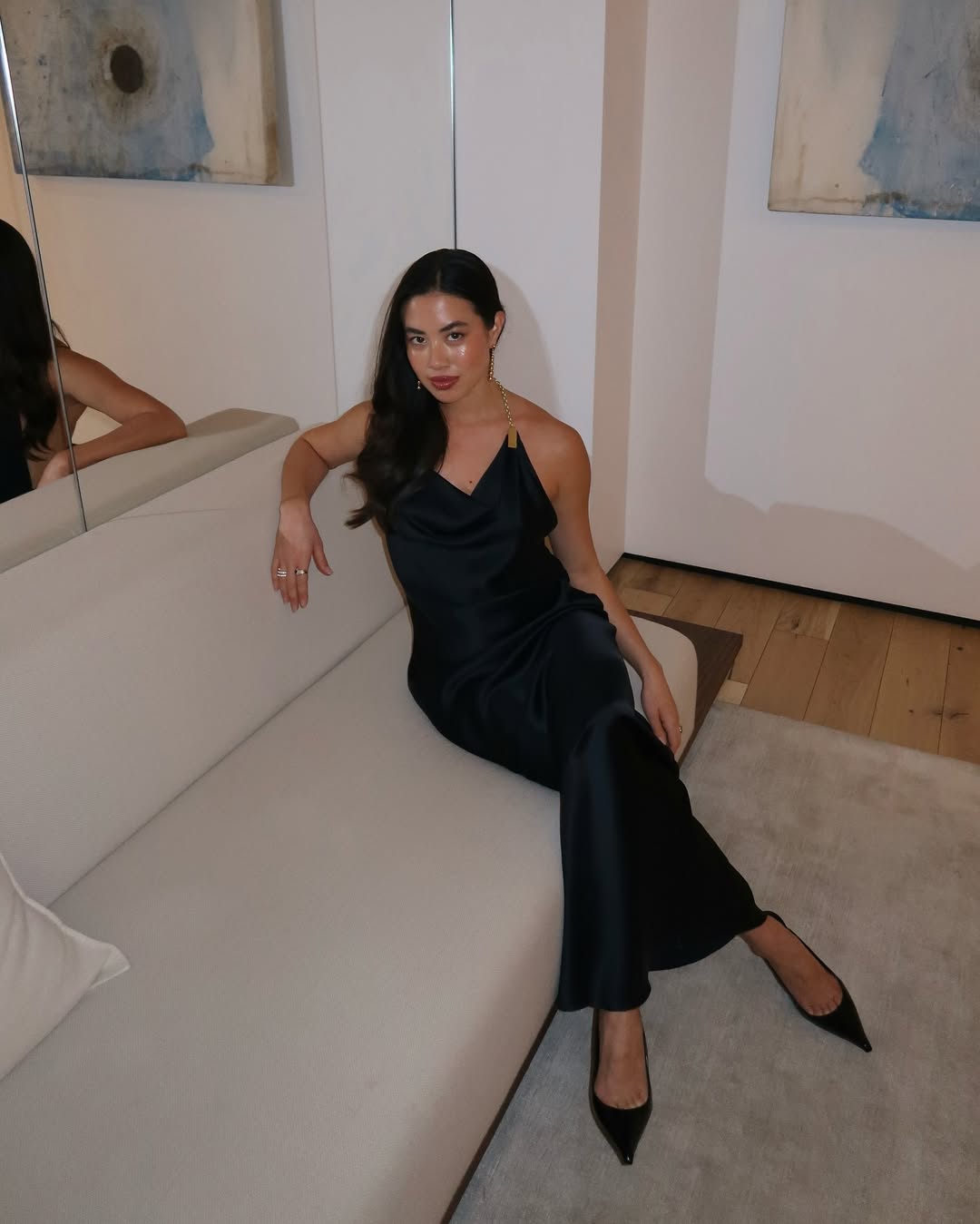 Sasha in a black dress and heels