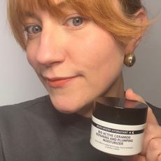 a headshot of matilda with a tub of the inkey list biactive ceramide plumping moisturiser